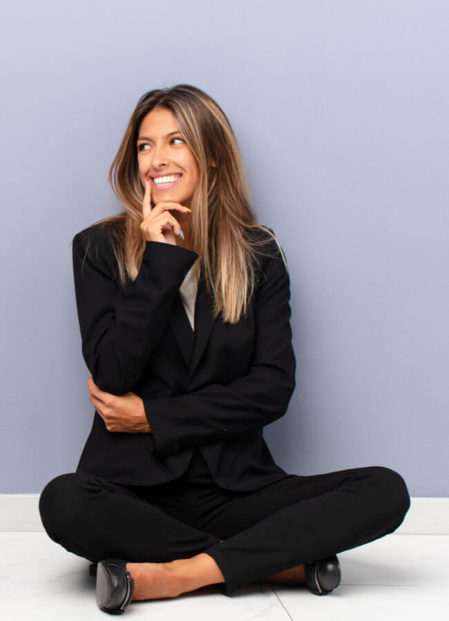 woman sitting against blue wall 3